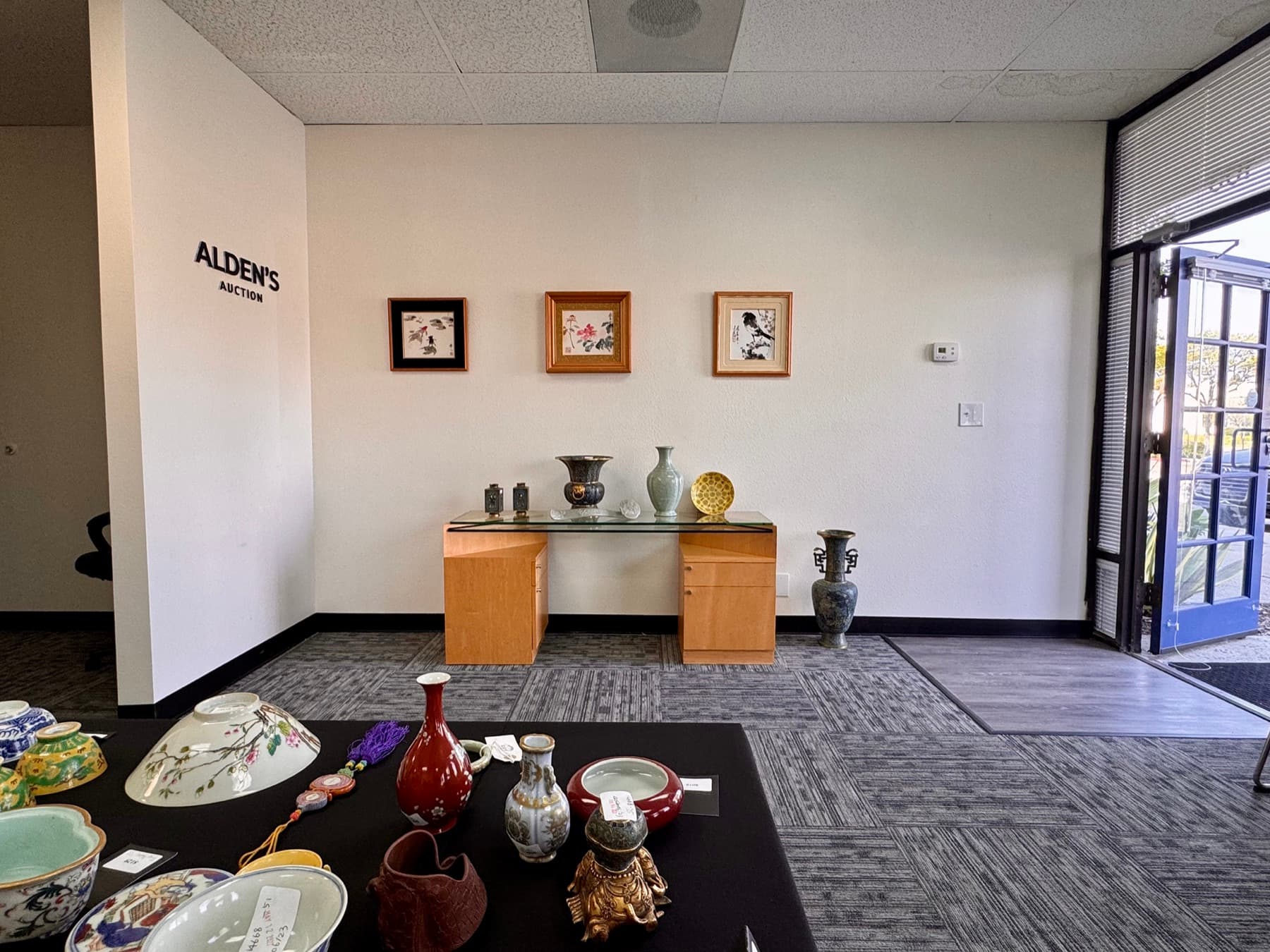 Alden's Auction Auction gallery display with Asian works of art